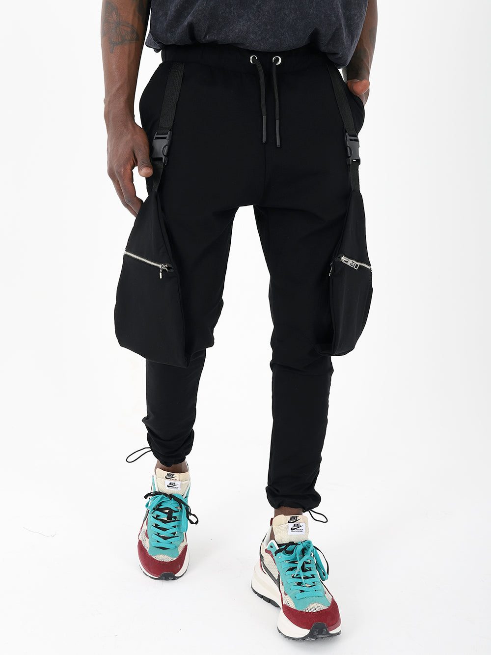 A stylish man in comfortable black Galaxy jogger pants and sneakers.