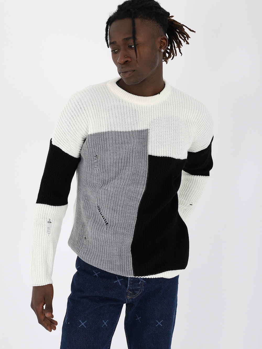 A man wearing a DISTRESSED GENTLEMAN SWEATER | MULTICOLOR sweater.