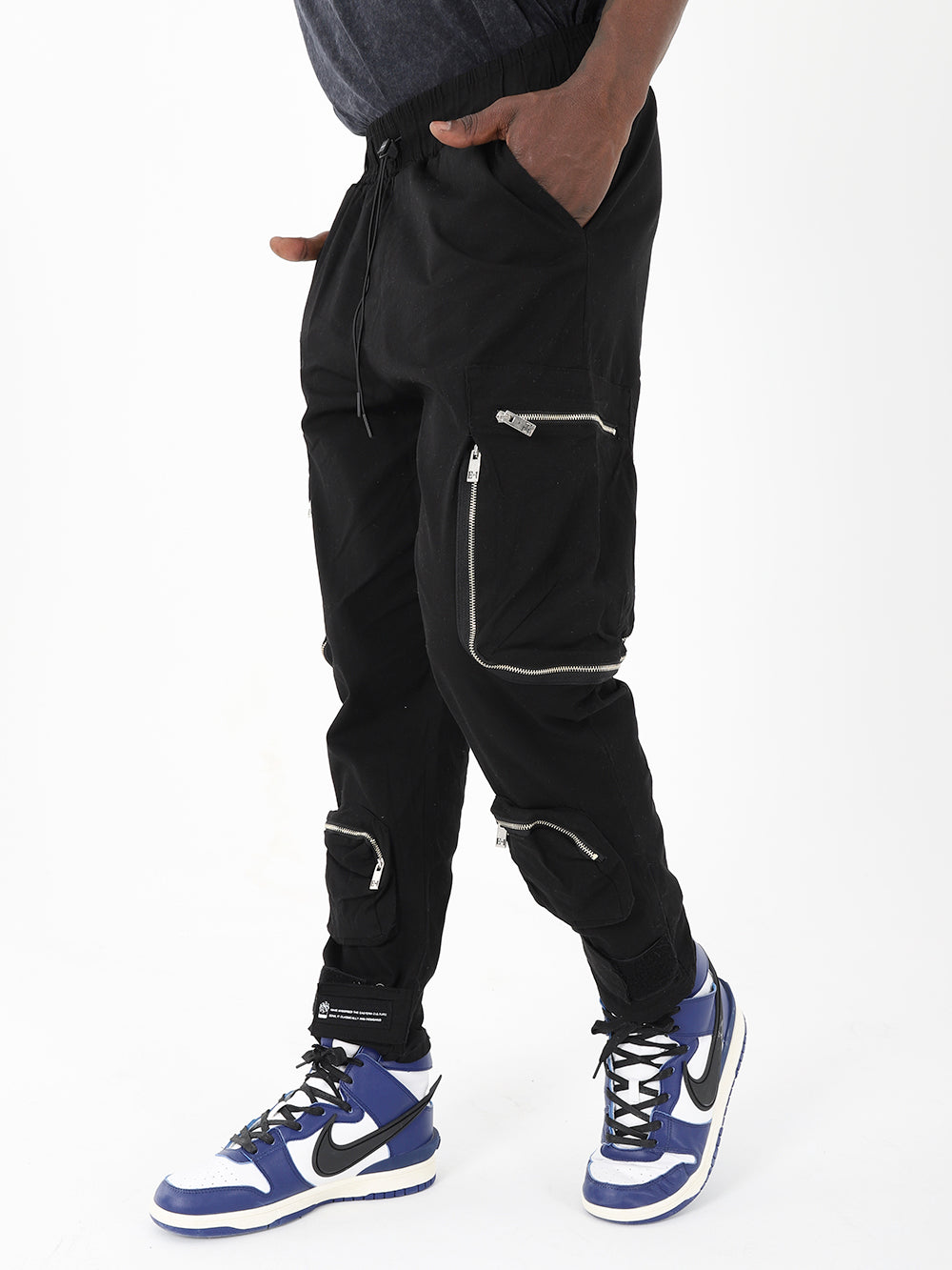 A man wearing RAIDER JOGGERS with zippers.