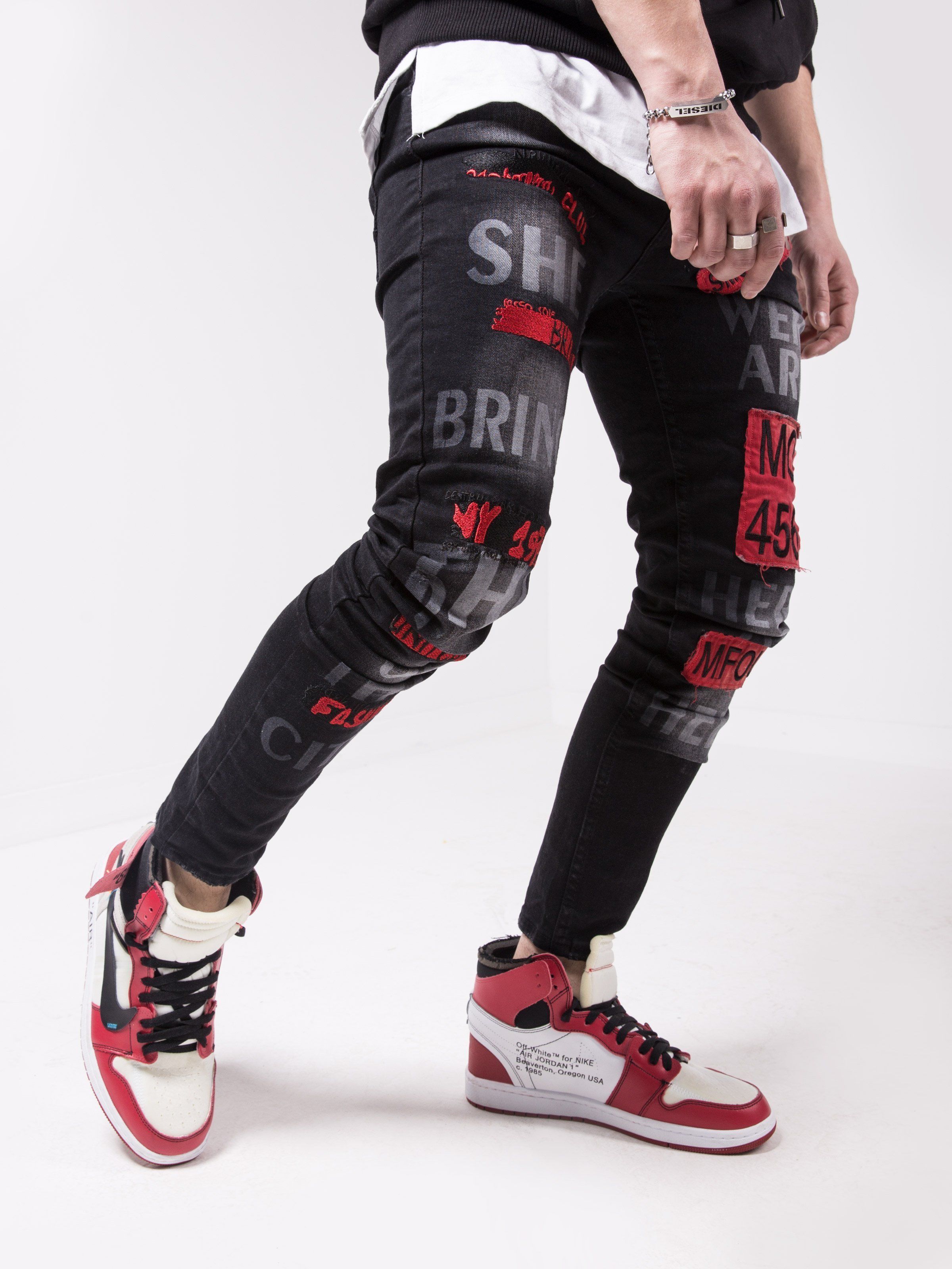 A man wearing a pair of GHETTO BIRD jeans.