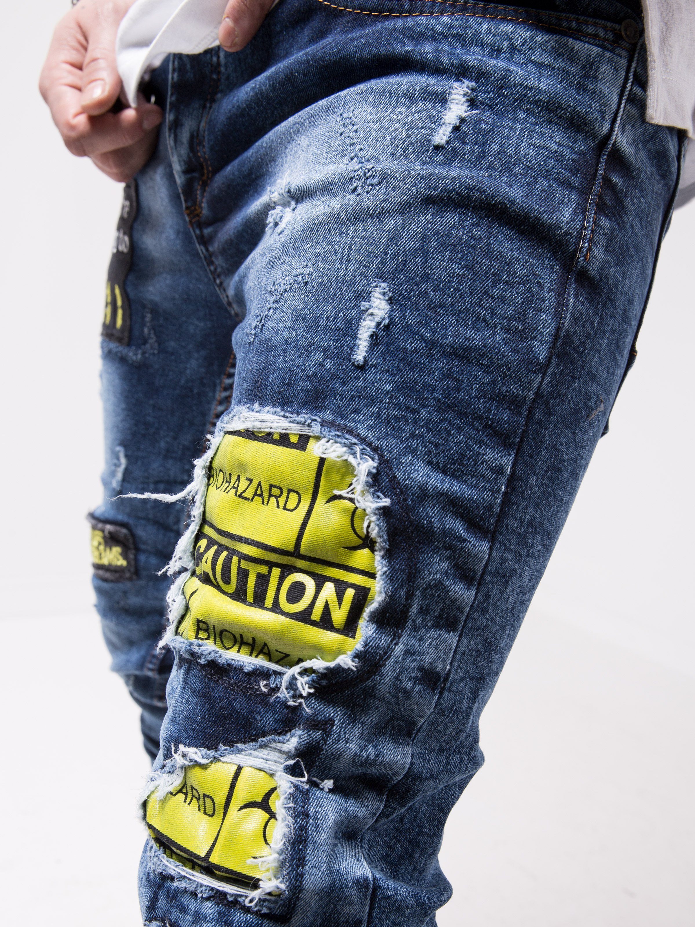 A man wearing ripped jeans with yellow patches, MOUNT EVEREST.