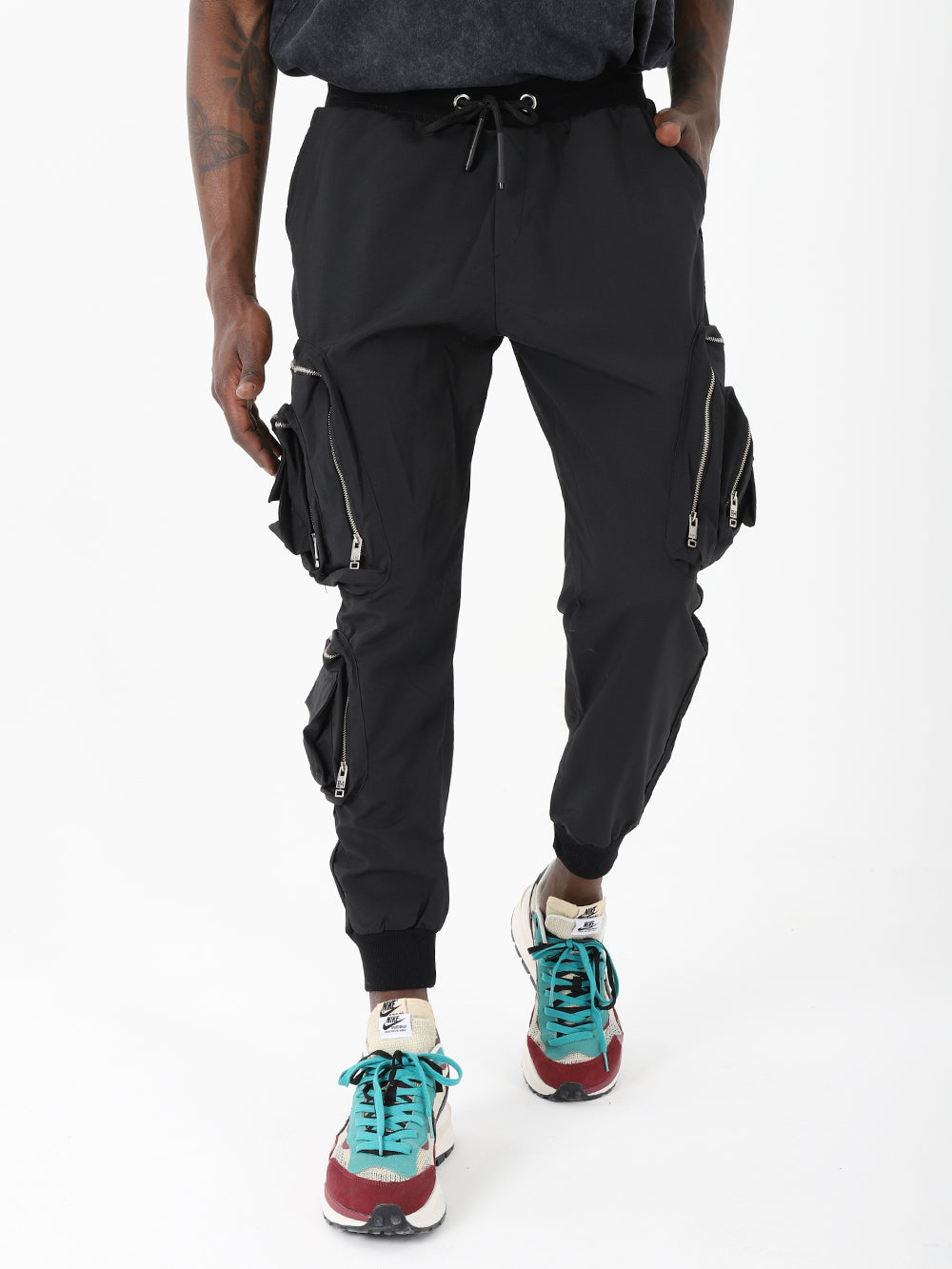 A man wearing LAVANO JOGGERS and sneakers.