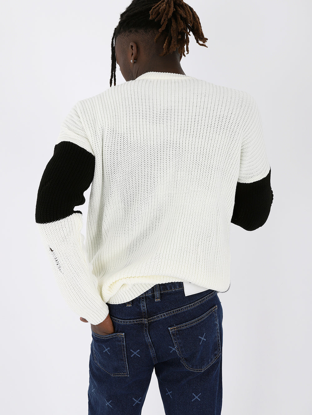 The back of a man wearing a Distressed Gentleman Sweater | Multicolor and jeans.