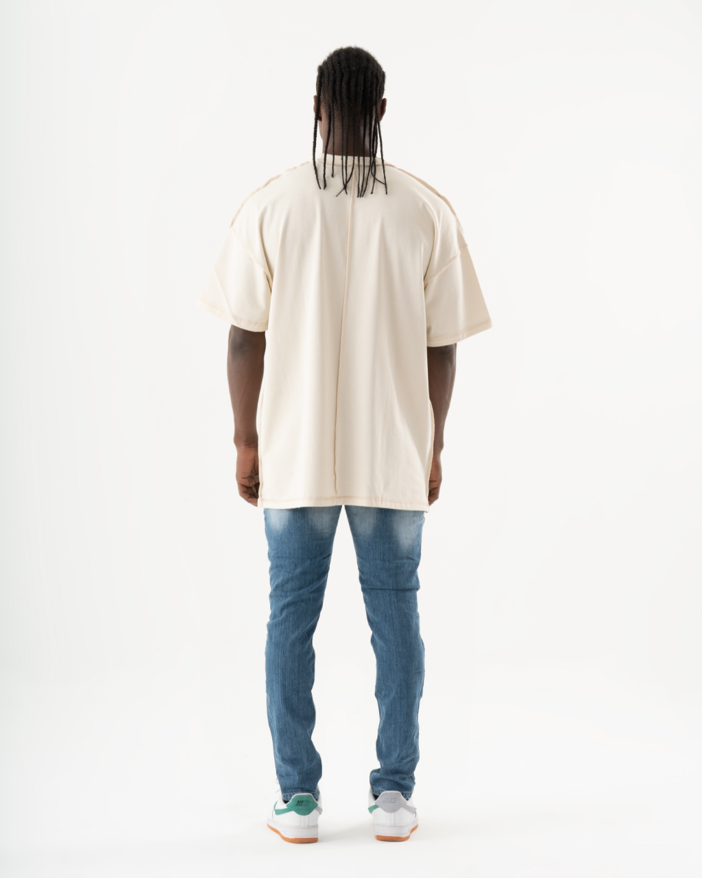 The back view of a man sporting TEZAR jeans and a t-shirt.