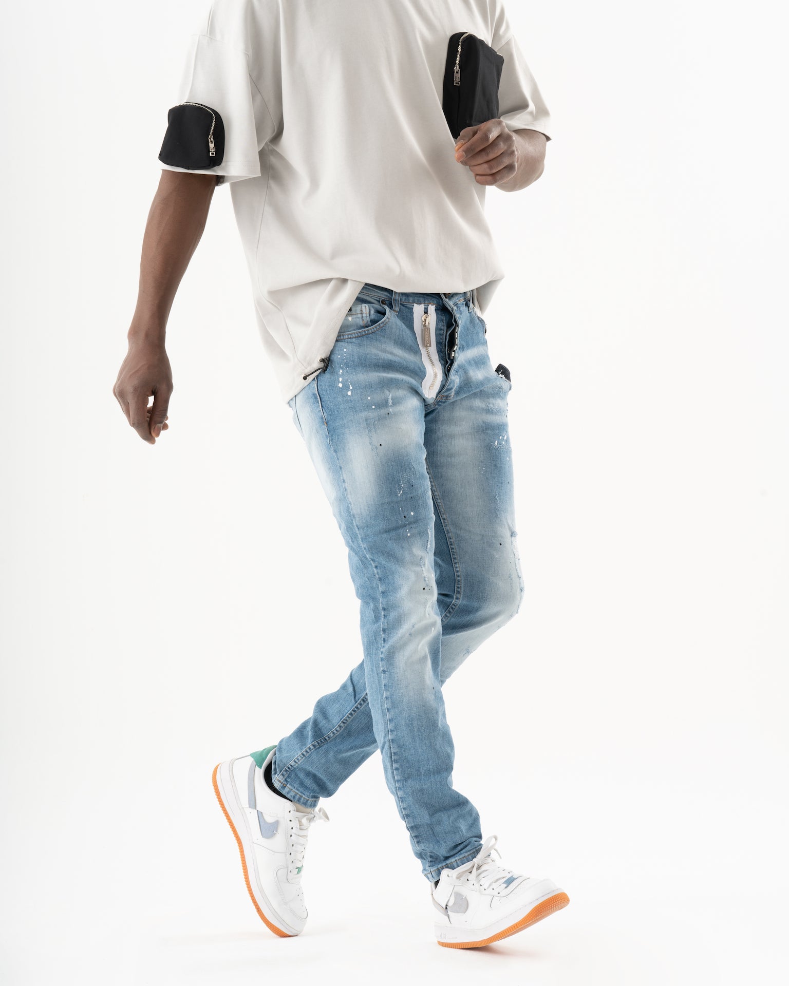 A man wearing SKATER jeans and a white t-shirt.