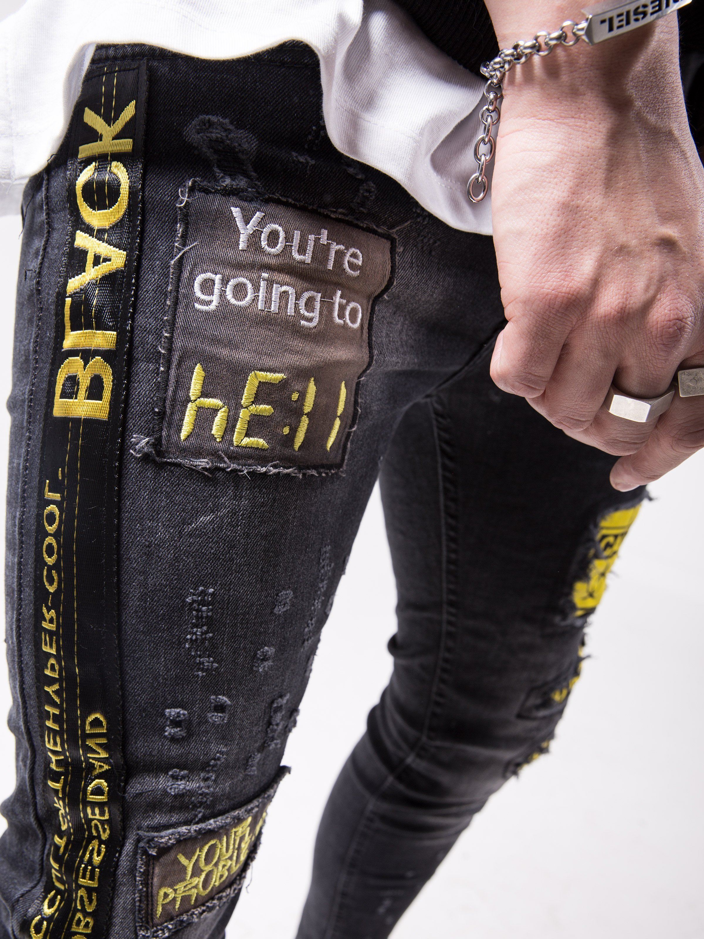 A man wearing a pair of BLACK FALCON with the words 'you're going to hell' on them.