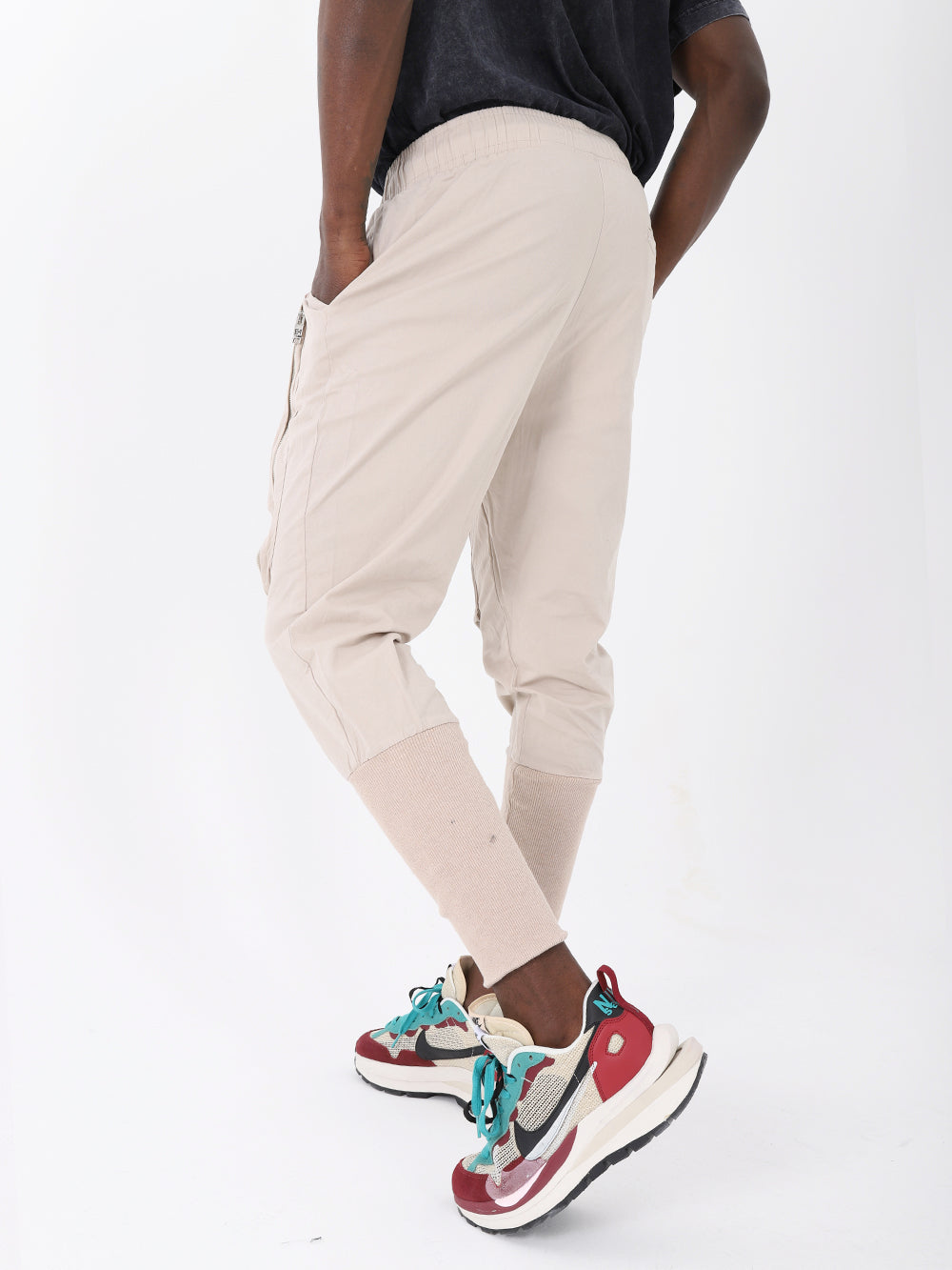 A man wearing ALTIS JOGGERS with an adjustable drawstring waist and black sneakers.