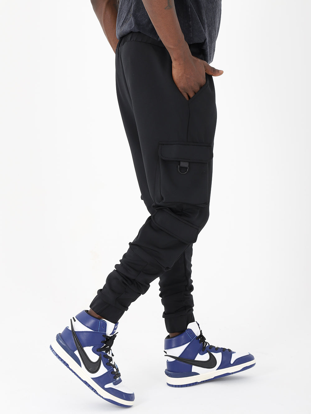 A man sporting VENTURA joggers with adjustable ankle cuffs and sneakers.