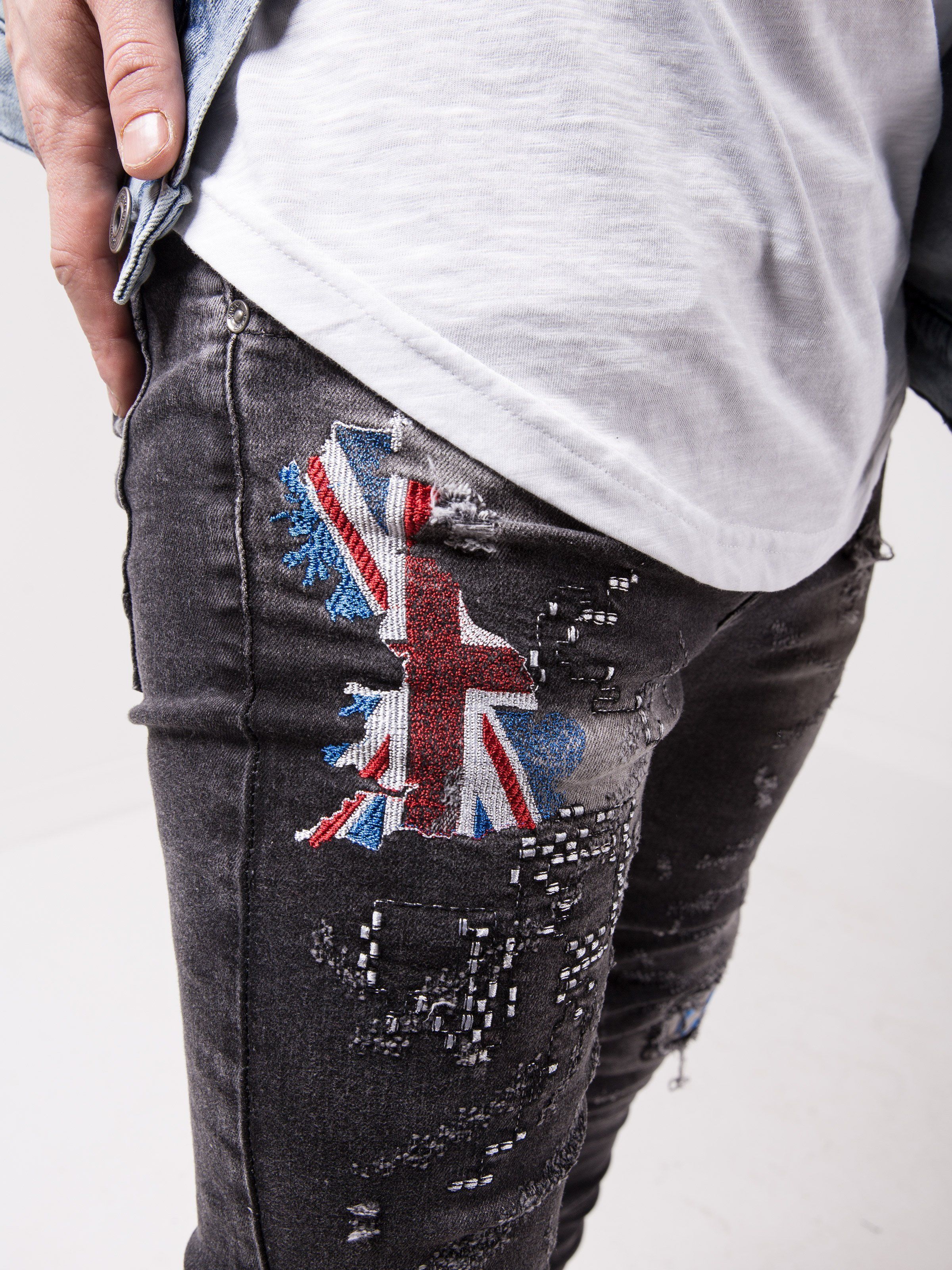 A man wearing a pair of BIG BEN jeans with a union jack patch.