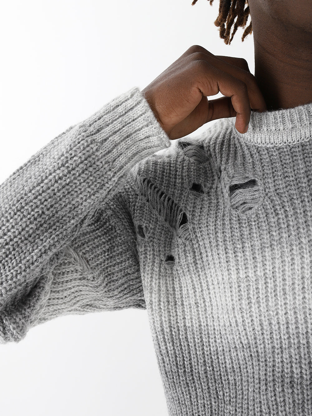 A black woman wearing a DISTRESSED GENTLEMAN SWEATER | WHITE-GRAY.