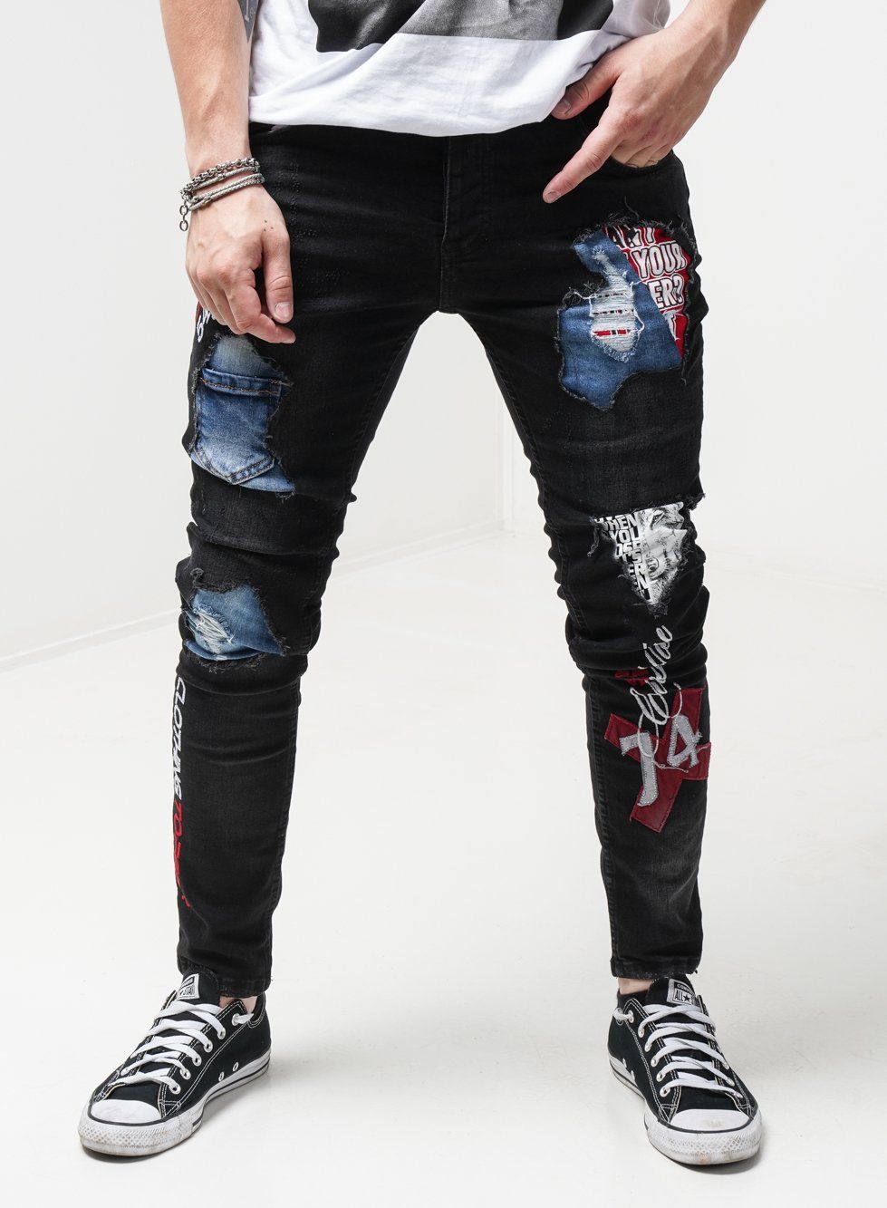 A man wearing INSIDER ripped jeans.
