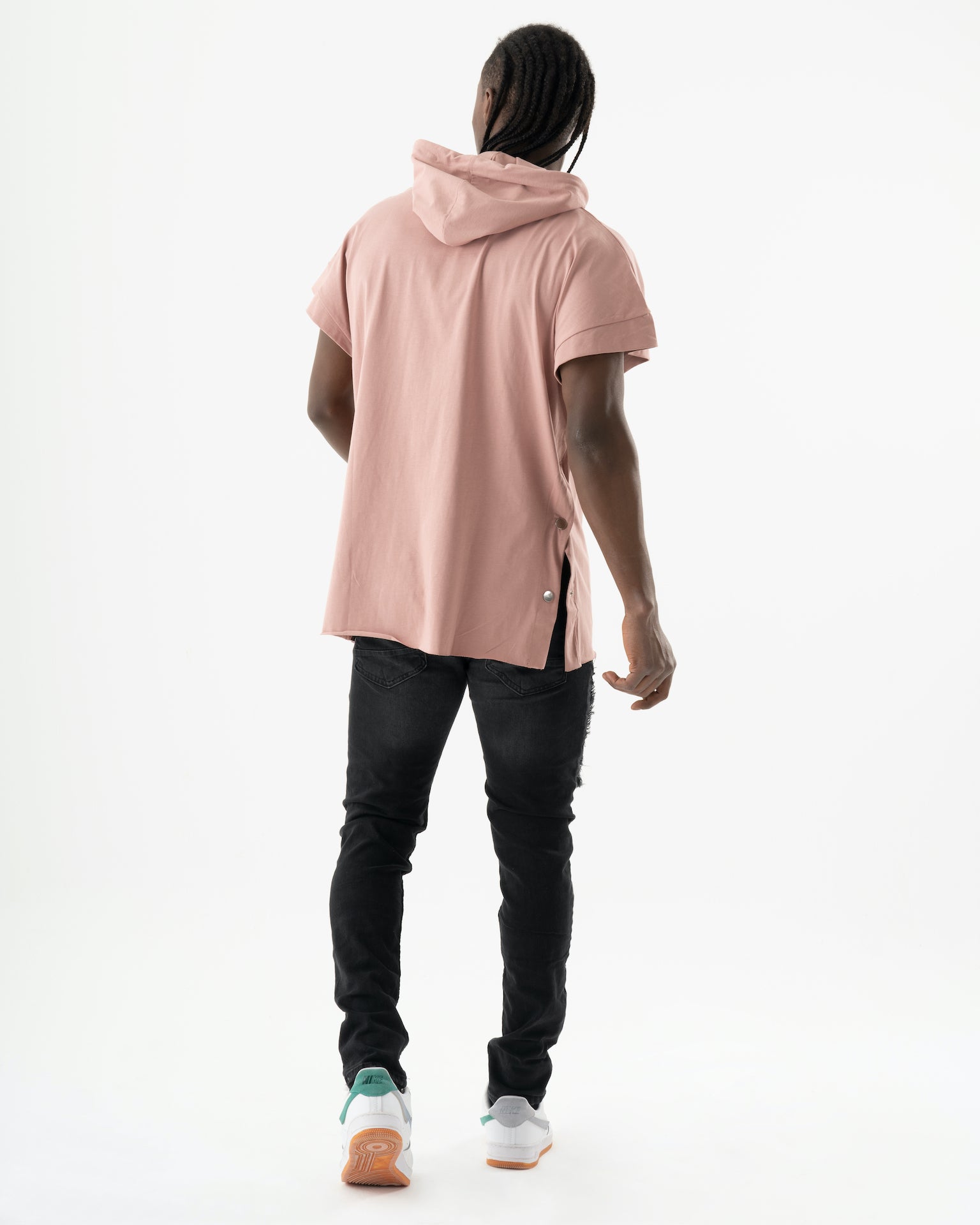 The back view of a man wearing the ONE SOUL pink hoodie.