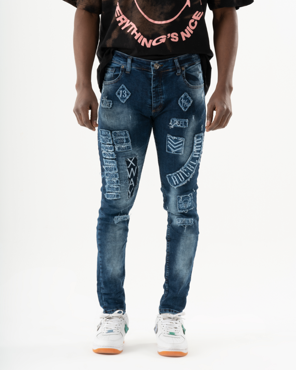A man in INJUN | BLUE skinny fit jeans and t-shirt.