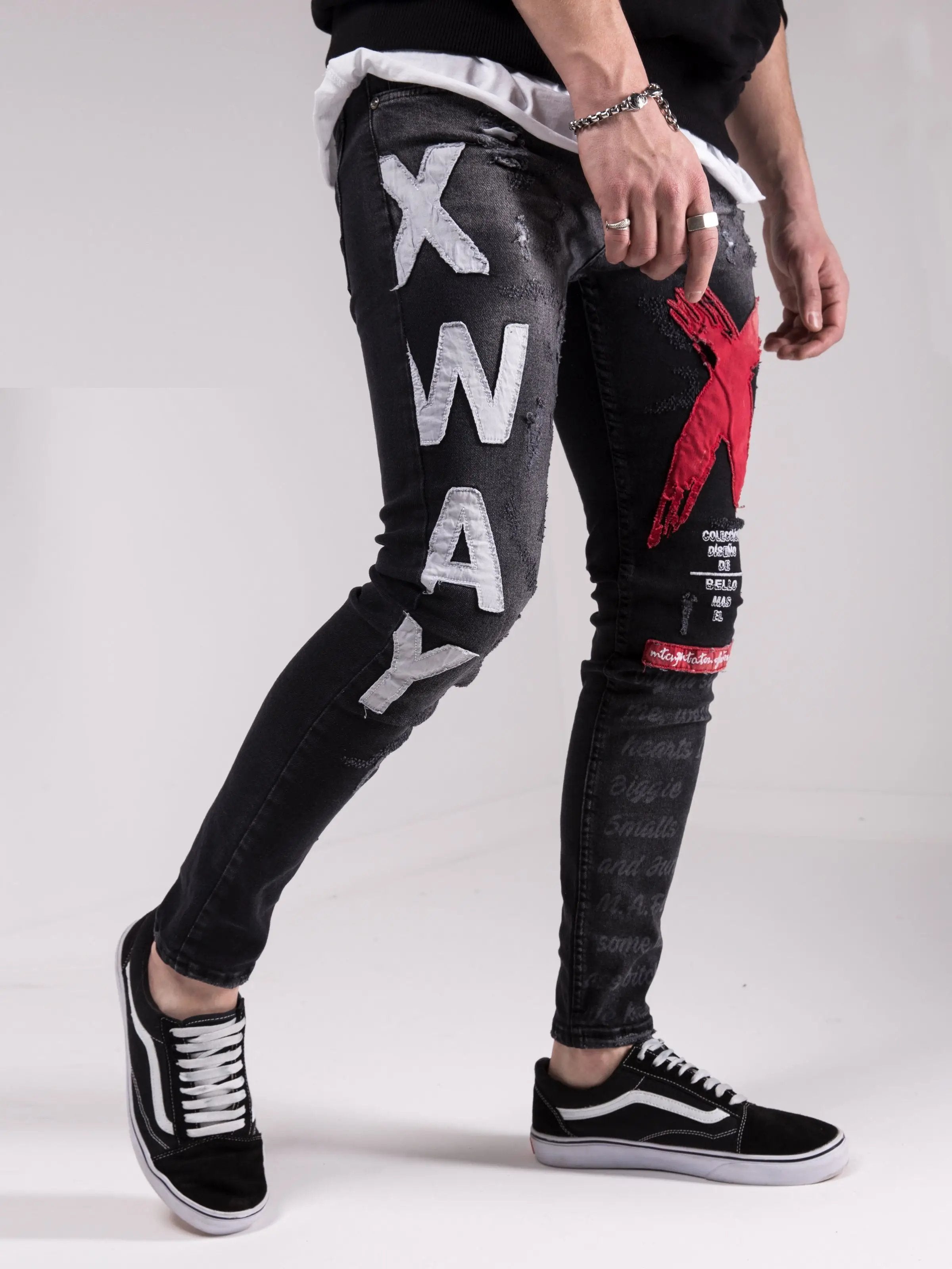 A man wearing a pair of MAD DOG skinny fit jeans with the word xway on them.