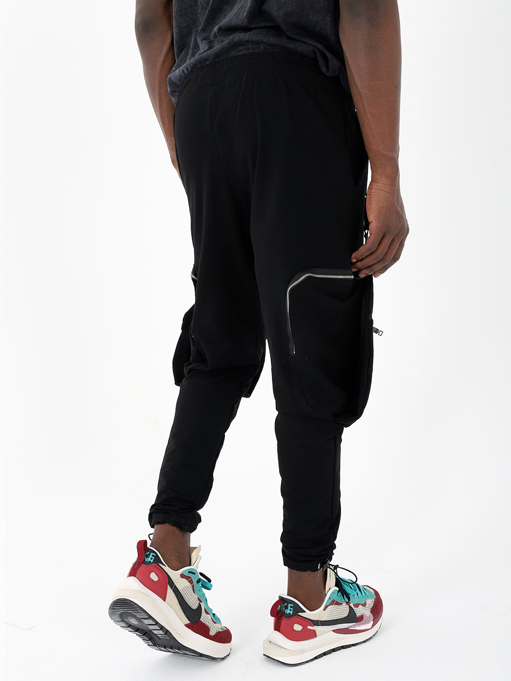 The stylish back of a man wearing comfortable black GALAXY joggers and sneakers.