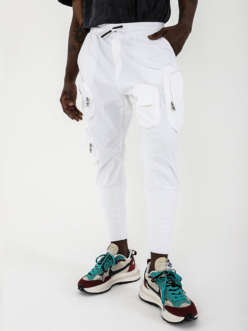 A man in comfortable white STERLING JOGGERS with adjustable drawstring waist.