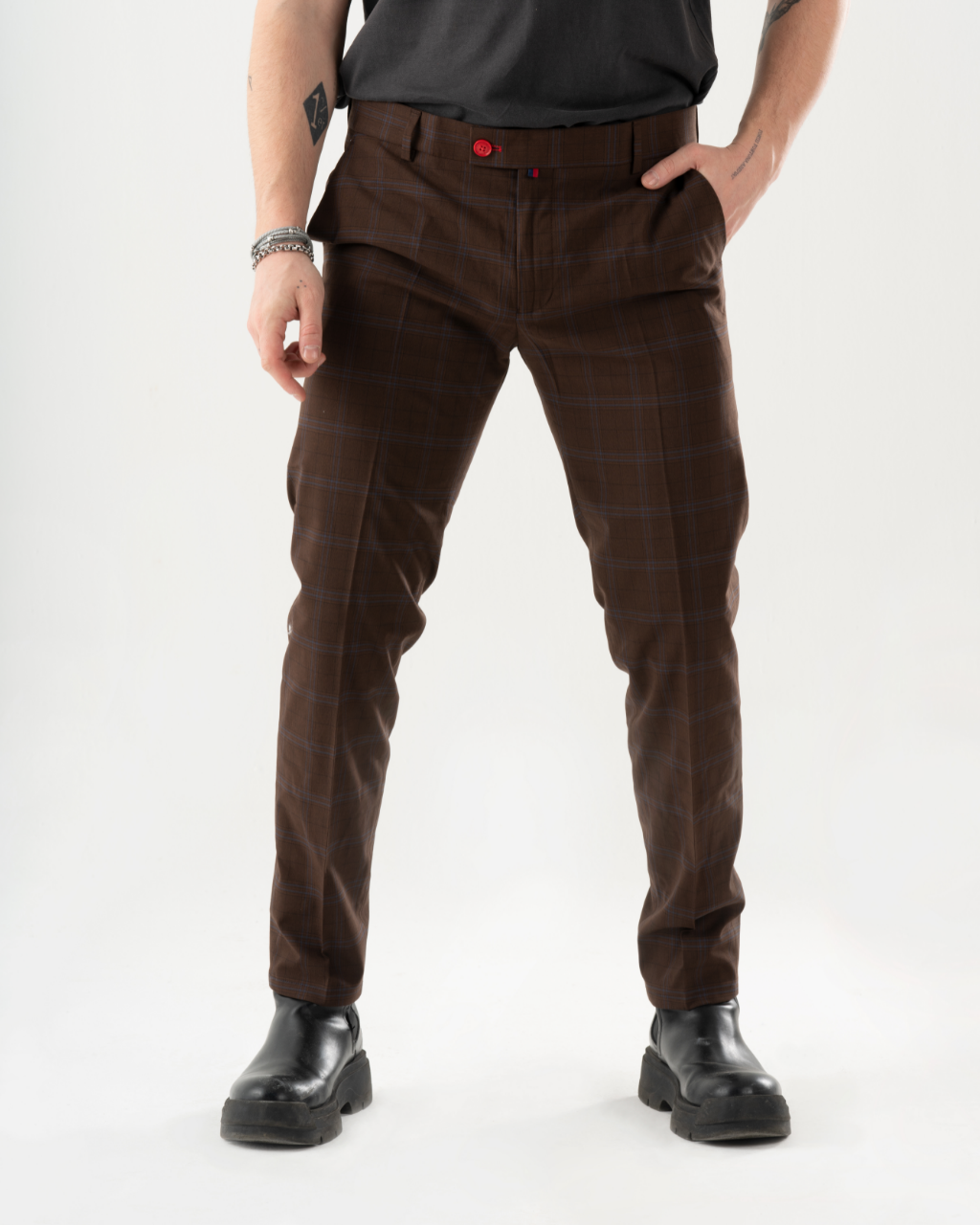 A man in a black shirt and HIGH-CASTLE PANTS is posing for a photo, showcasing his trendy mens streetwear.