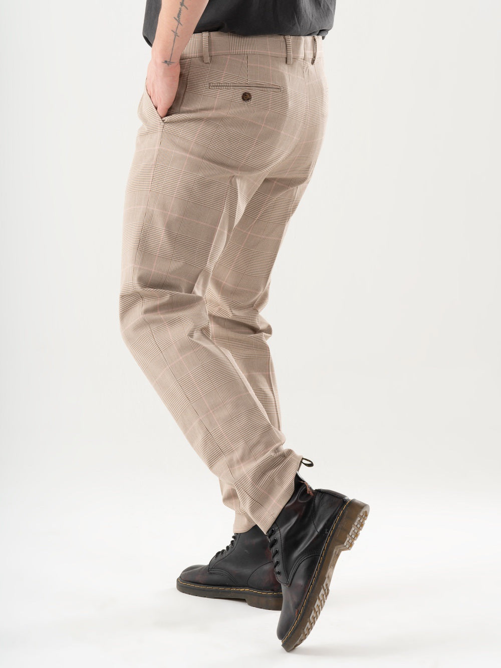 A man is standing in a studio wearing Moonshot pants.