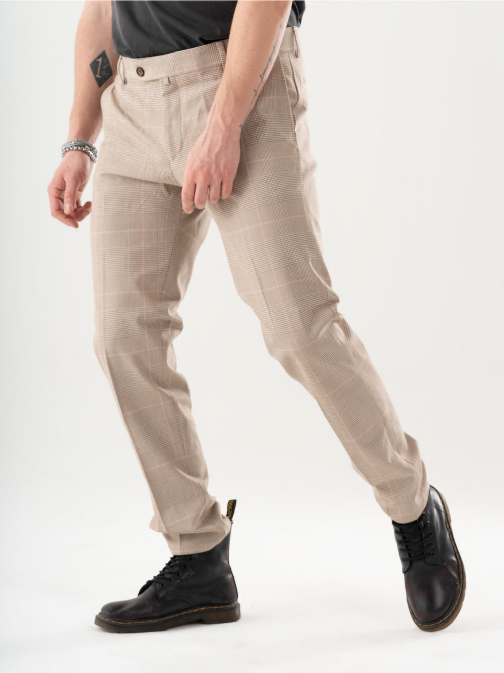 A man is standing in a studio wearing MOONSHOT PANTS.