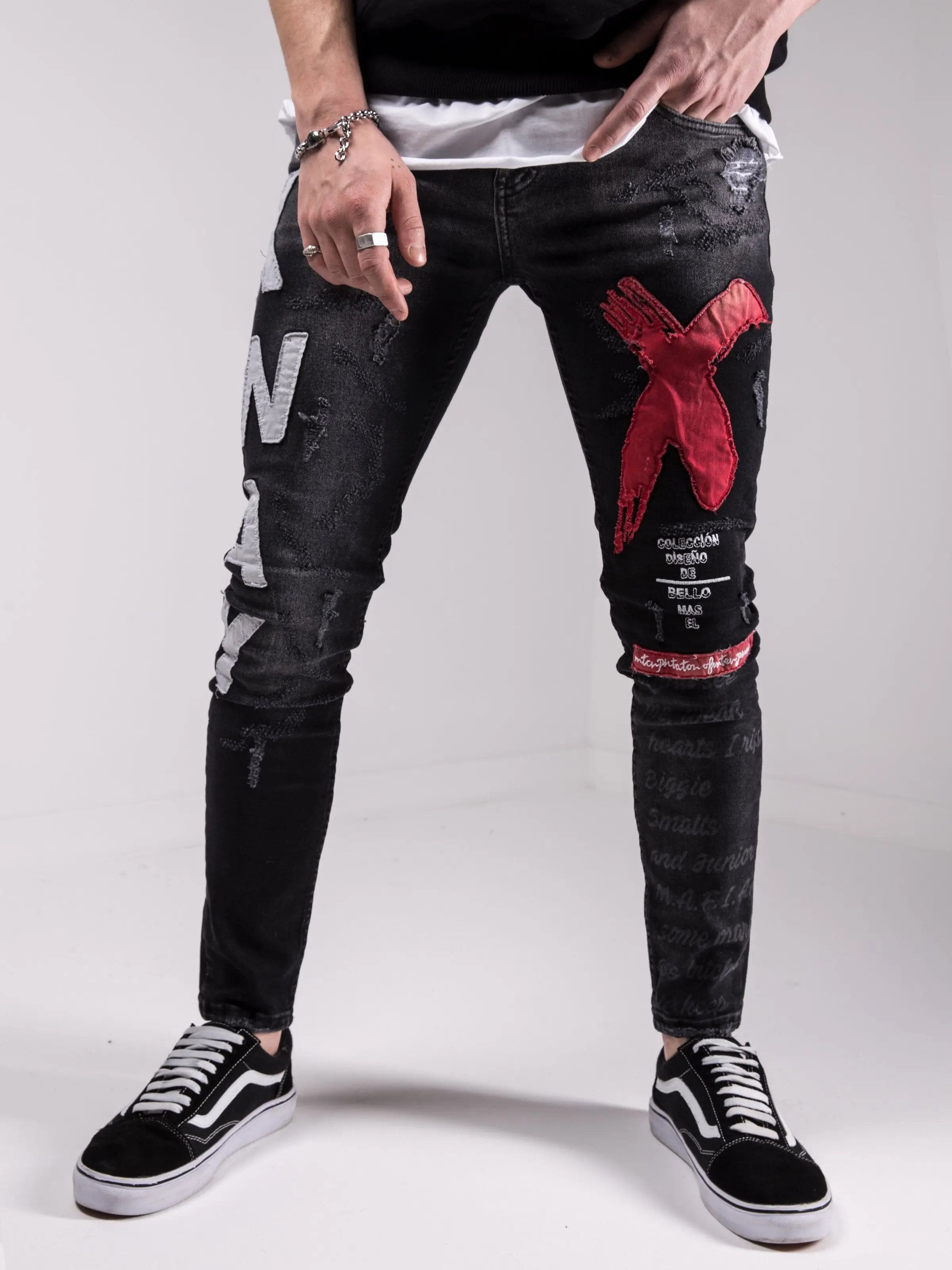 A man wearing a pair of MAD DOG skinny fit black jeans.