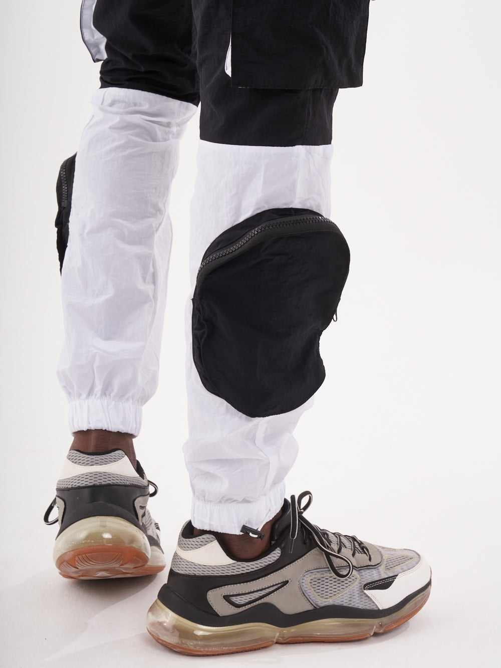 A man wearing a pair of RENEGADE | BLACK joggers with elastic ankles.