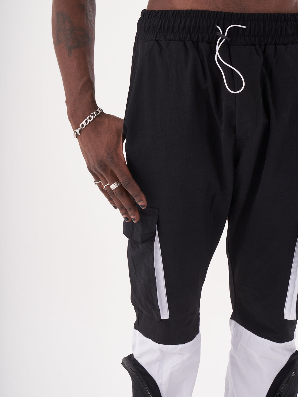 A man wearing RENEGADE | BLACK cargo pants with cargo pockets.