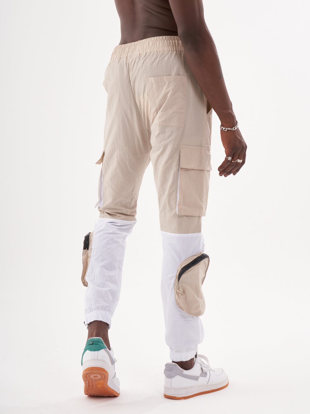 The back view of a man wearing RENEGADE | BEIGE cargo pants.