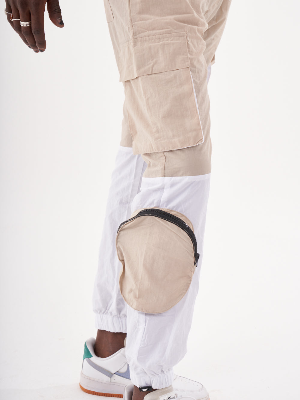 A man wearing a RENEGADE | BEIGE cargo pants.