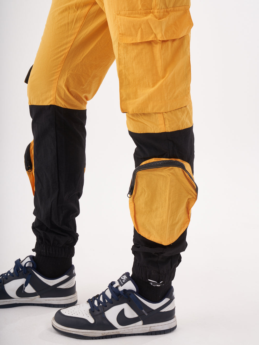 The back of a man wearing RENEGADE | YELLOW cargo pants.