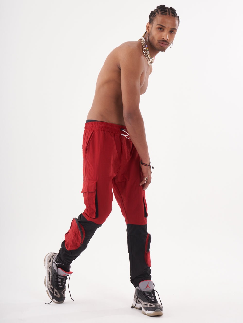 A man in RENEGADE | RED joggers posing in front of a white background.