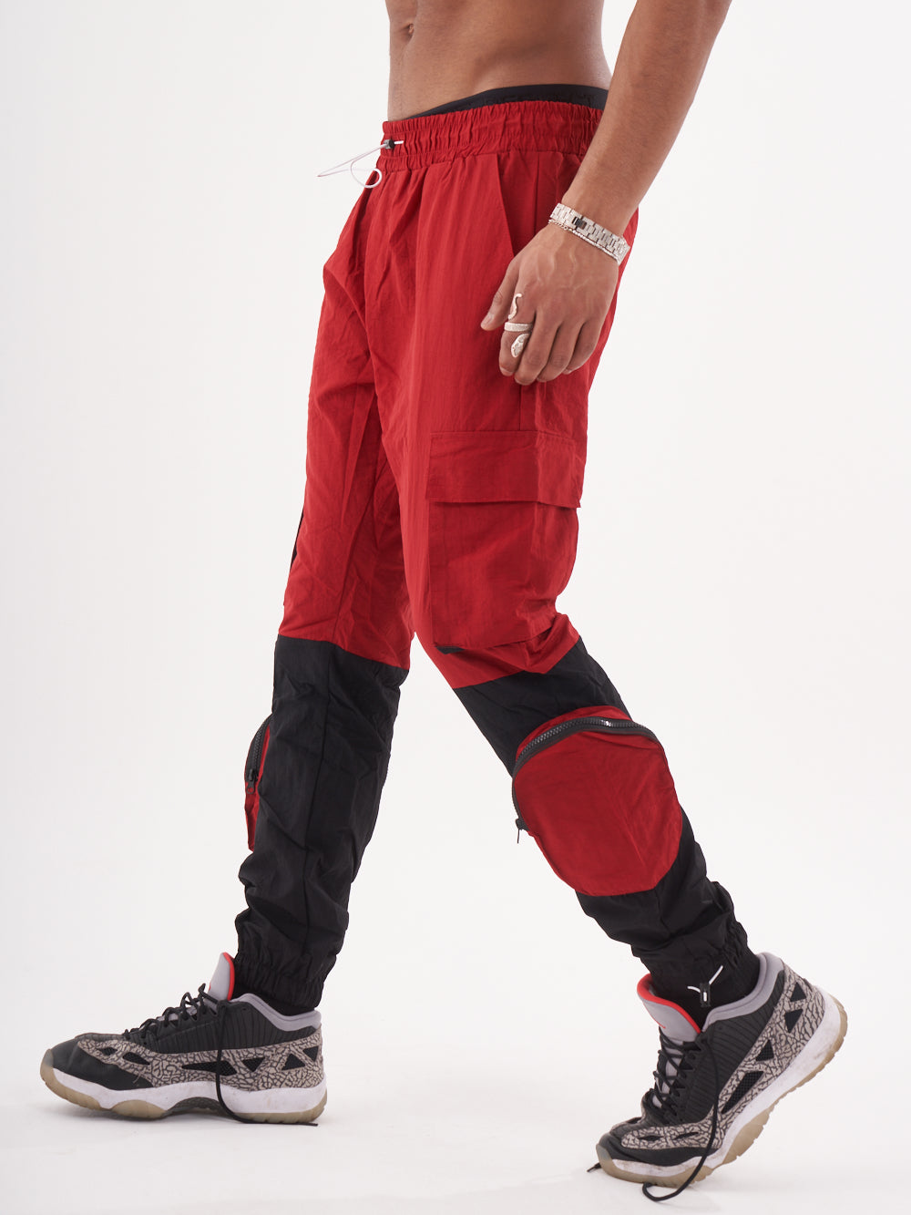 A man wearing RENEGADE | RED jogging pants.