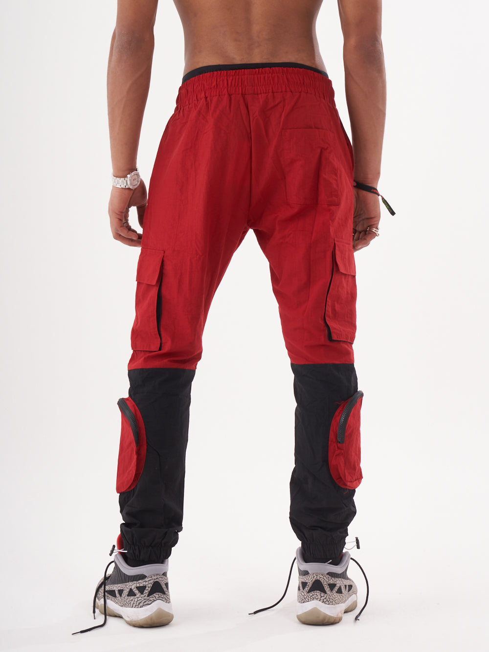 The back view of a man wearing RENEGADE | RED cargo pants.
