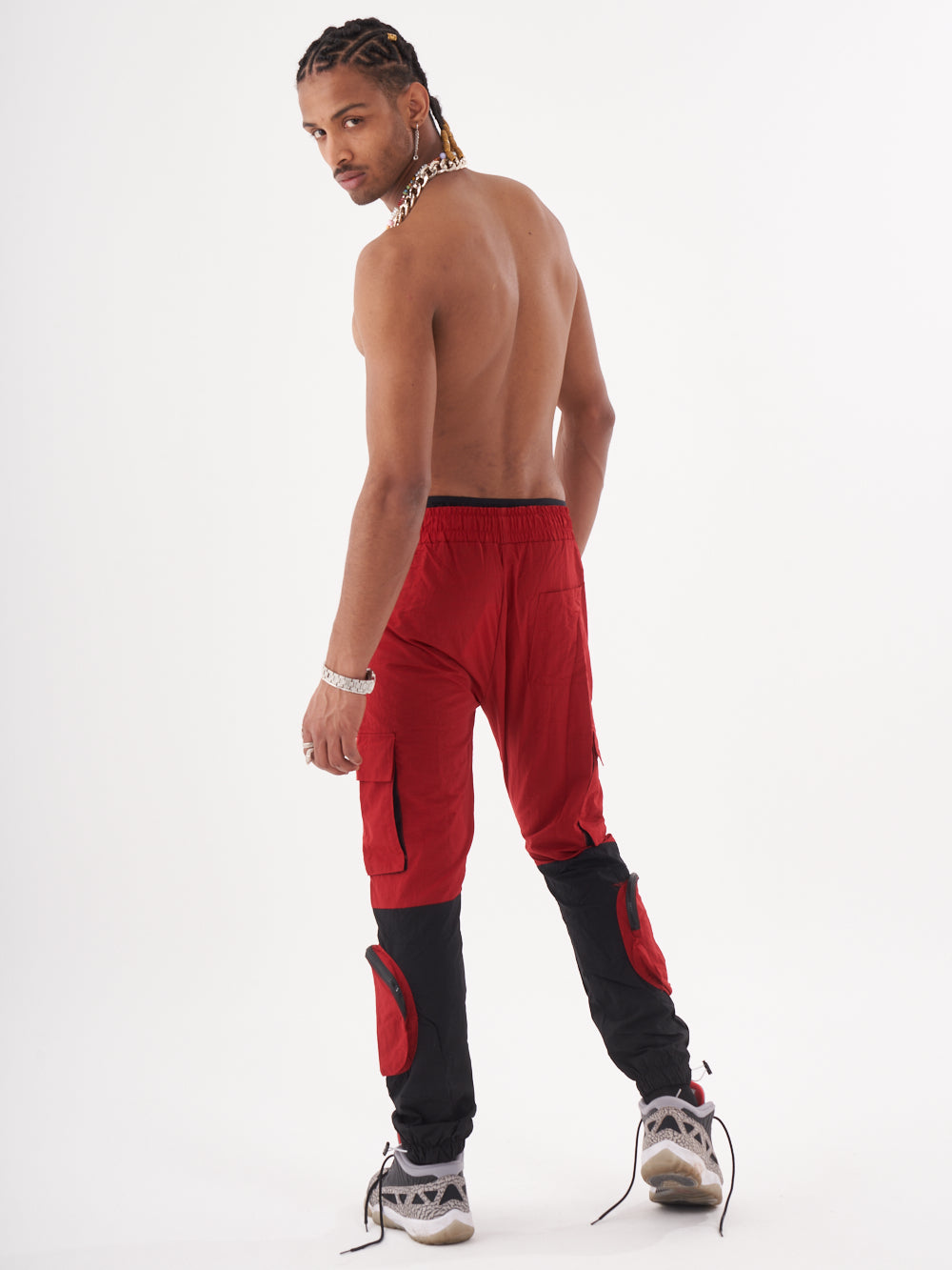 The back of a man wearing RENEGADE | RED jogging pants.