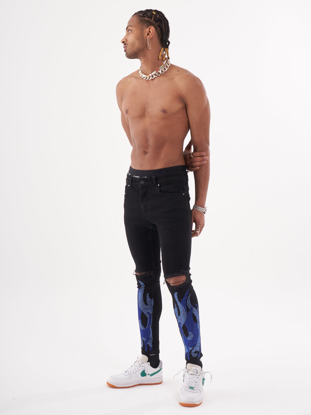 A man wearing HELLFIRE | BLUE jeans with blue flames on them.