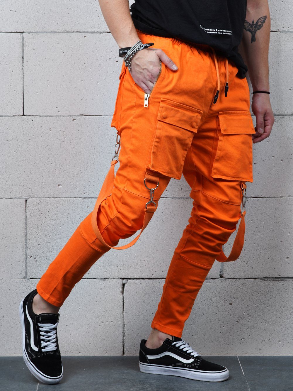 A man wearing the ORANGE BRONX cargo pants and black sneakers.