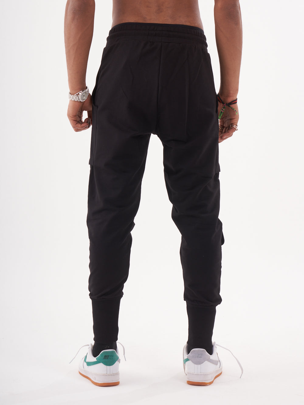 The back view of a man wearing GUERRILLA | BLACK jogger pants.
