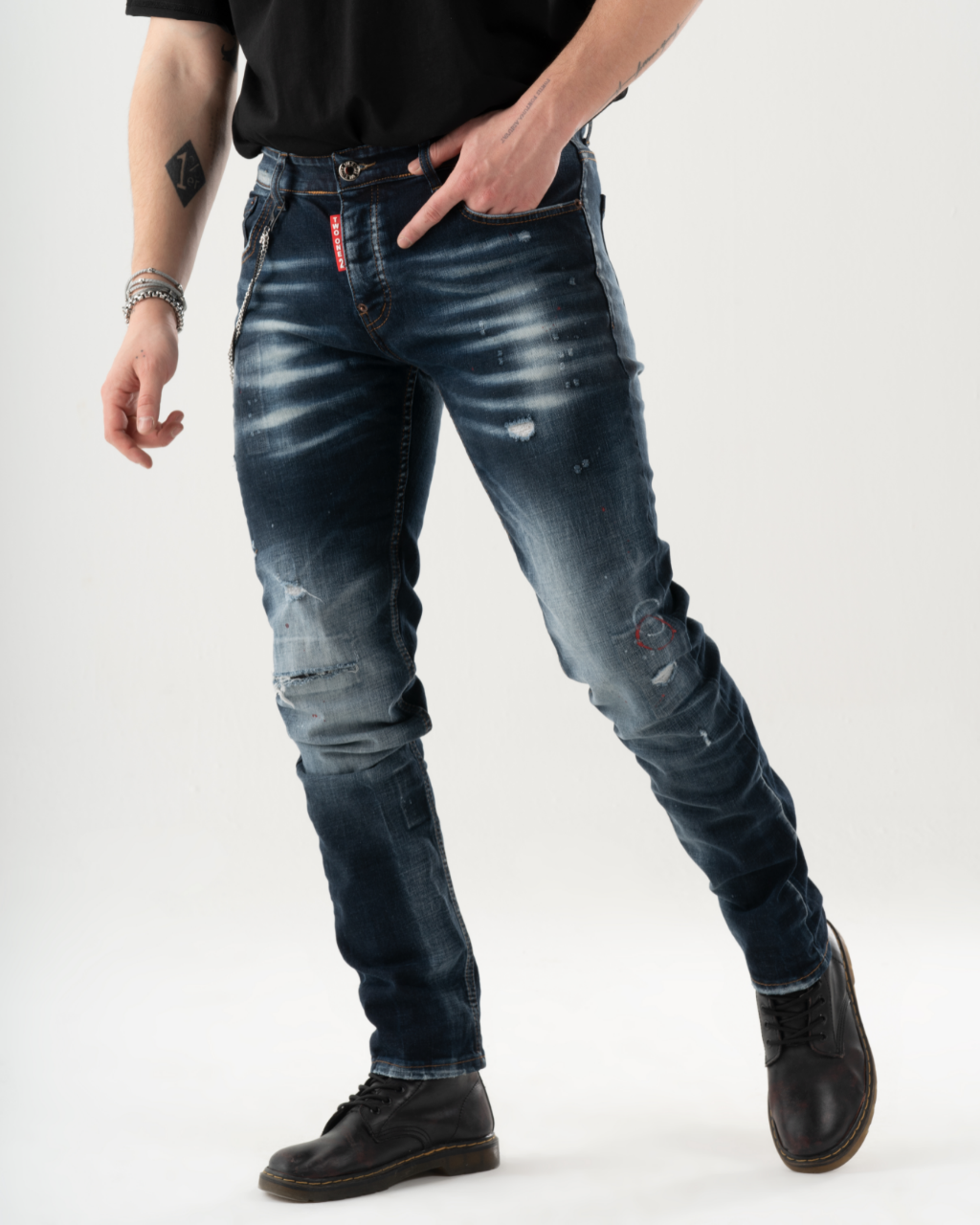 A man is standing in a studio wearing LIGHTNING skinny fit blue jeans.