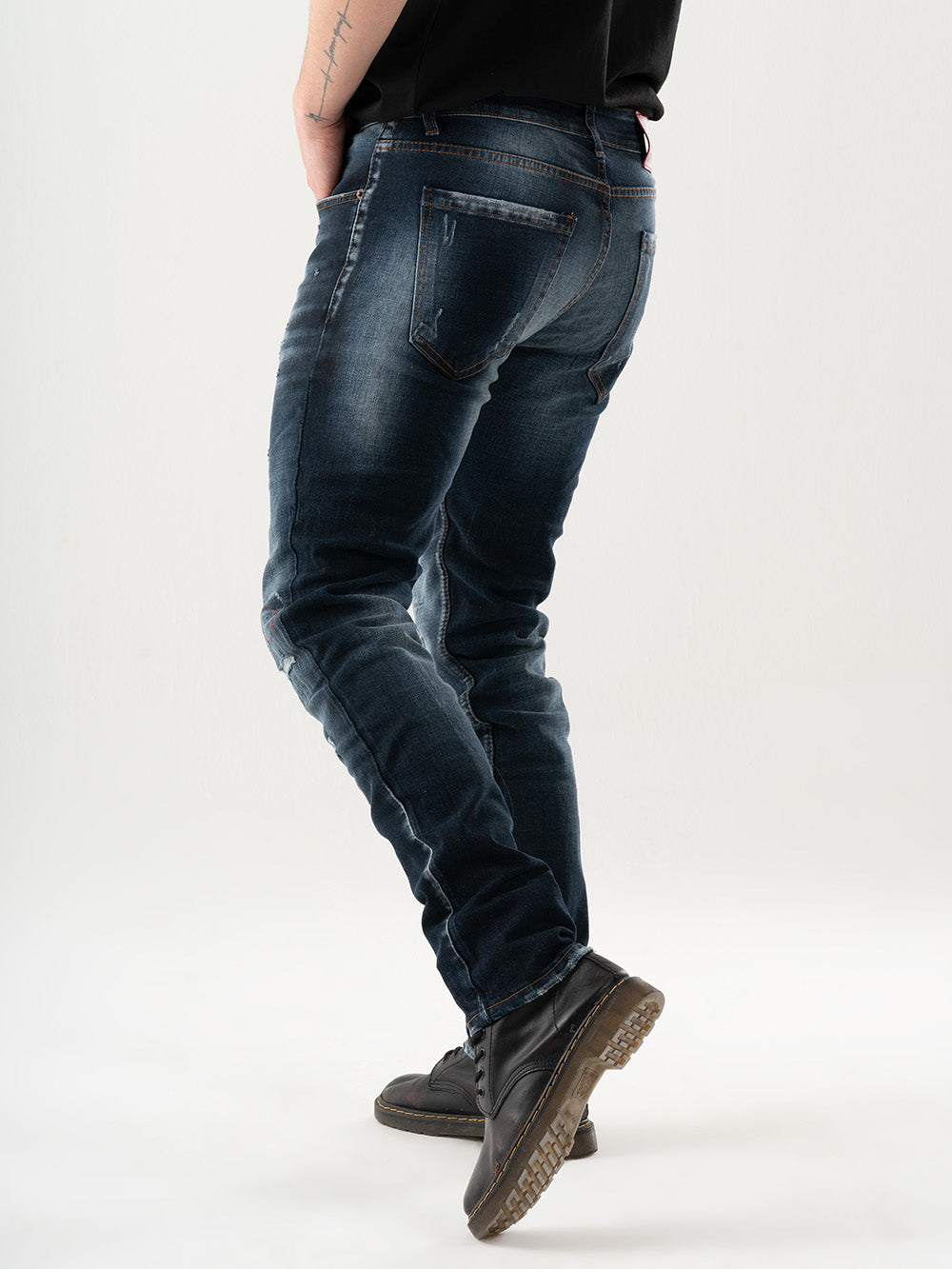 A man wearing LIGHTNING jeans is standing in front of a white background.