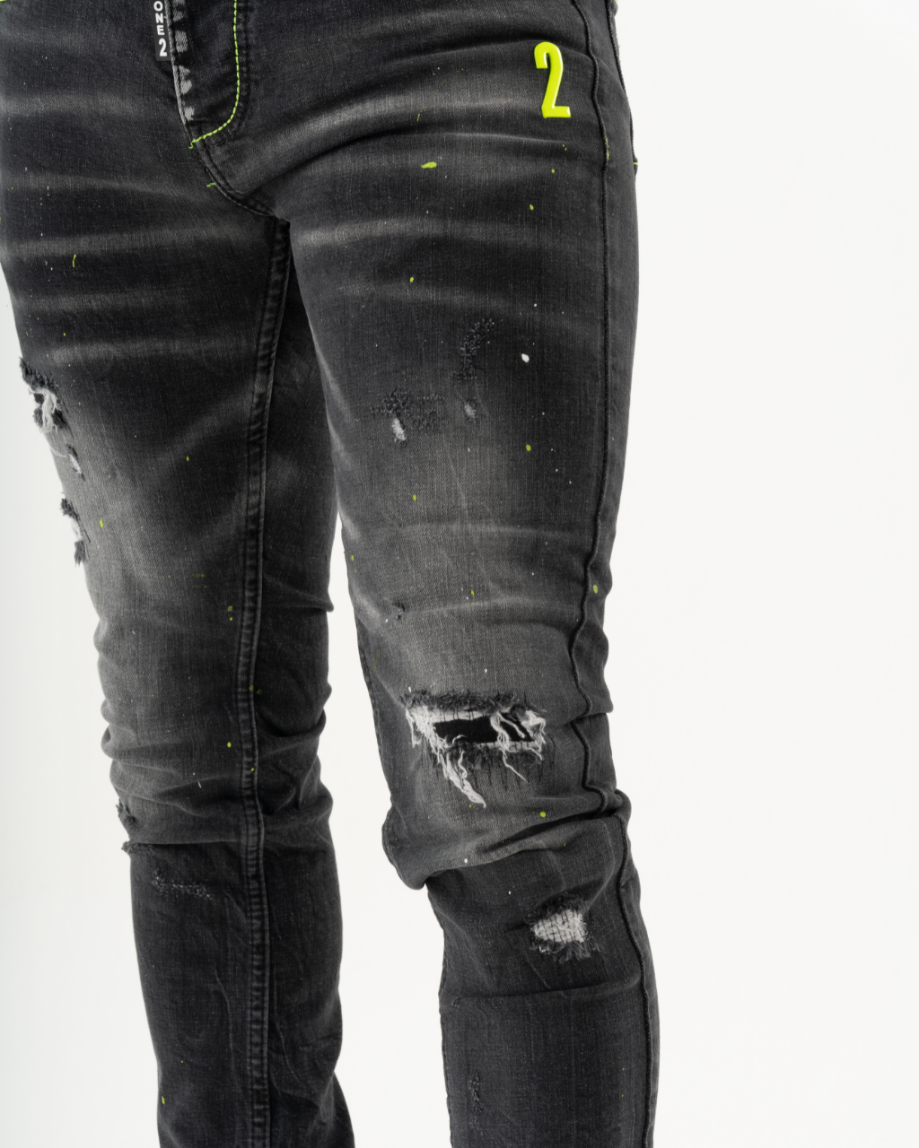 A man wearing INKLING skinny fit jeans with neon paint on them.