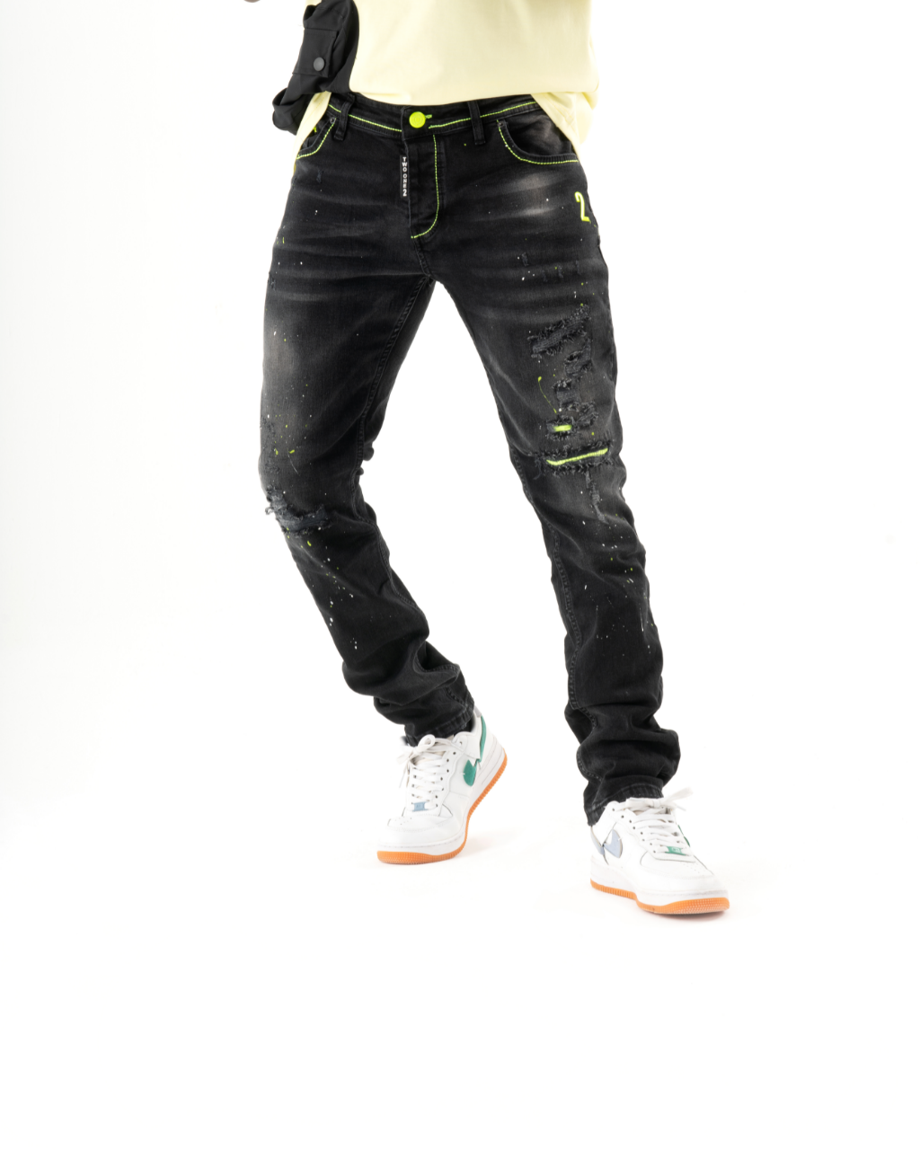 A man in skinny fit black TWILIGHT jeans is posing.