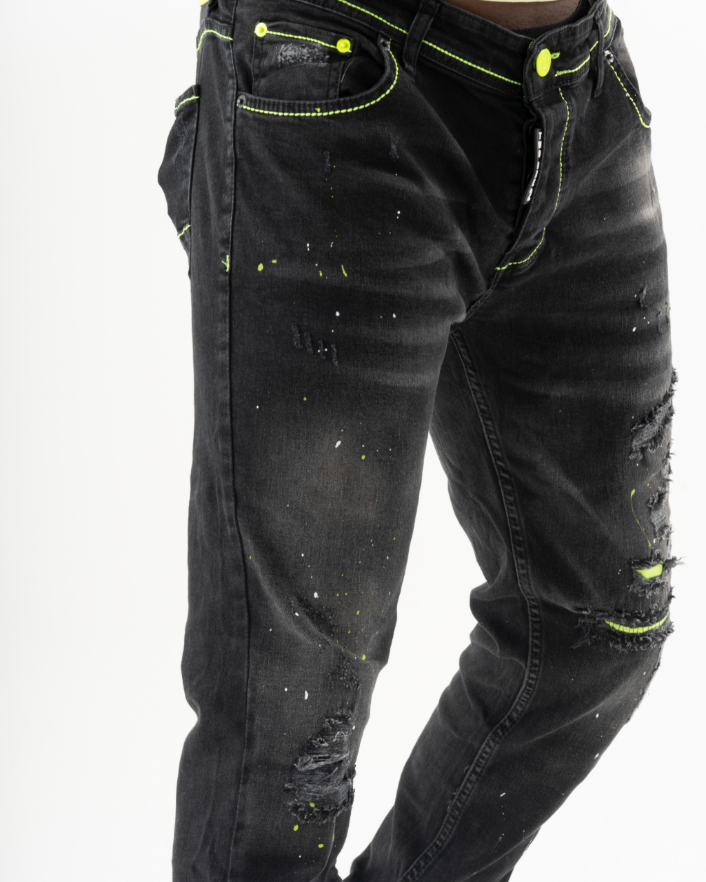A man wearing a pair of TWILIGHT skinny fit black jeans with neon accents.