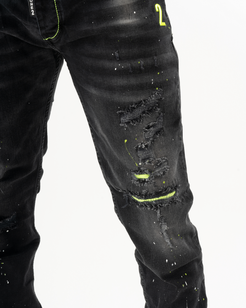 A man wearing ripped jeans with neon paint on TWILIGHT.
