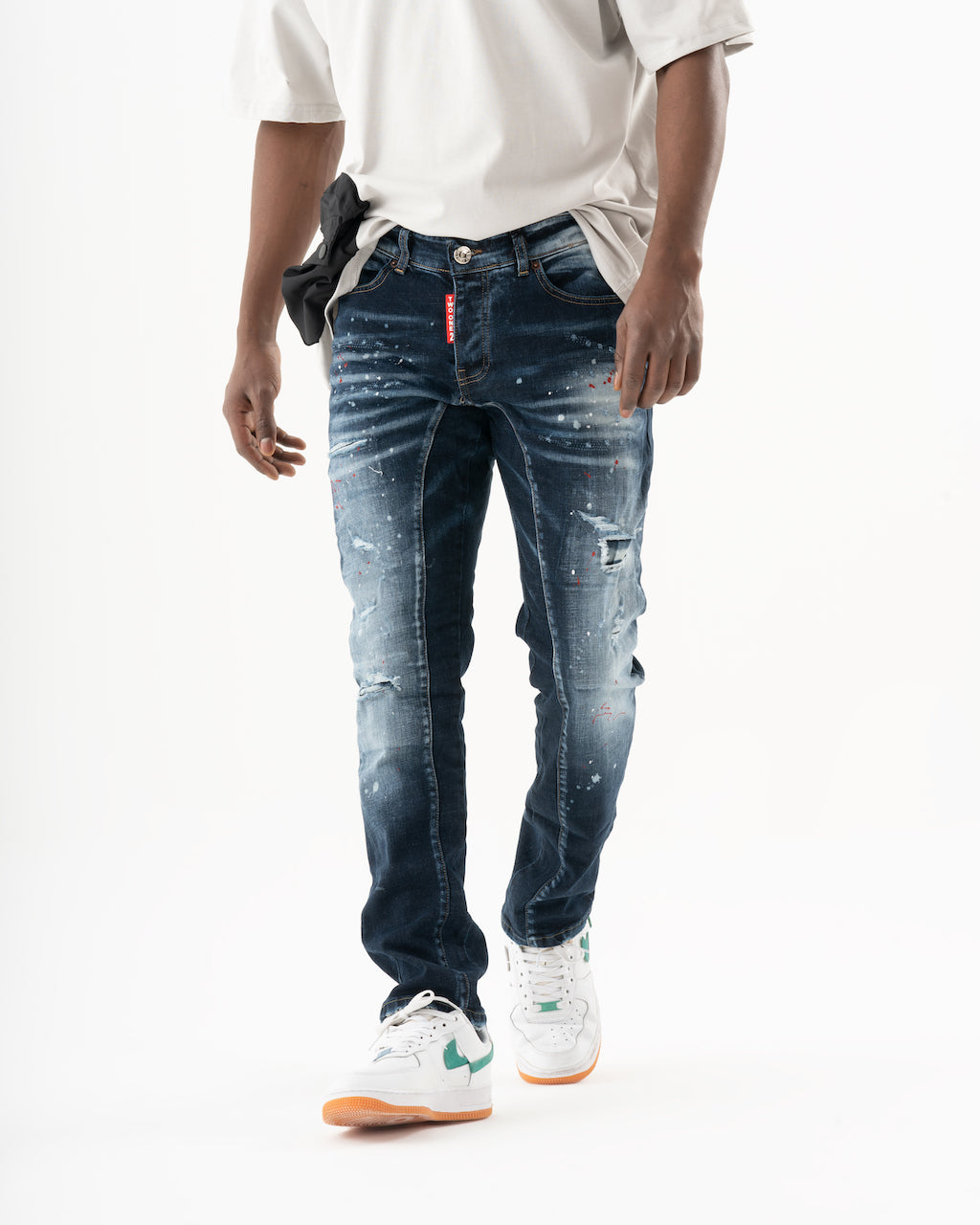 A man wearing STARLIGHT jeans and a white t-shirt.