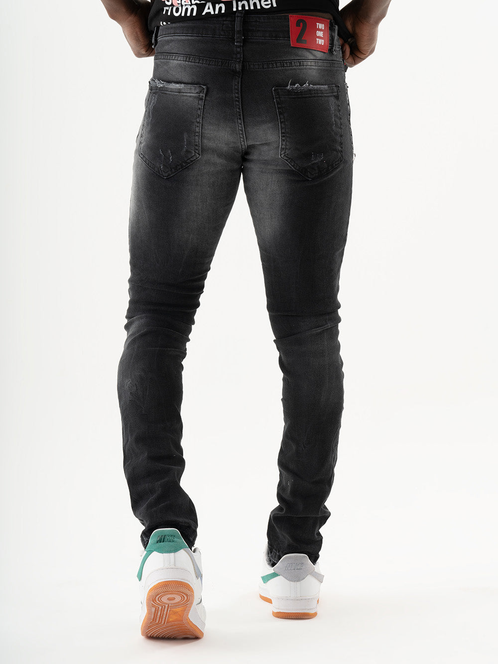 The back of a man wearing black skinny fit jeans with added stretch THUNDERBIRD.