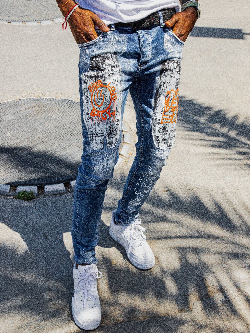 Man wearing the skinny fit WANDERLUST Streetwear Jeans by SERNES with bold graphics