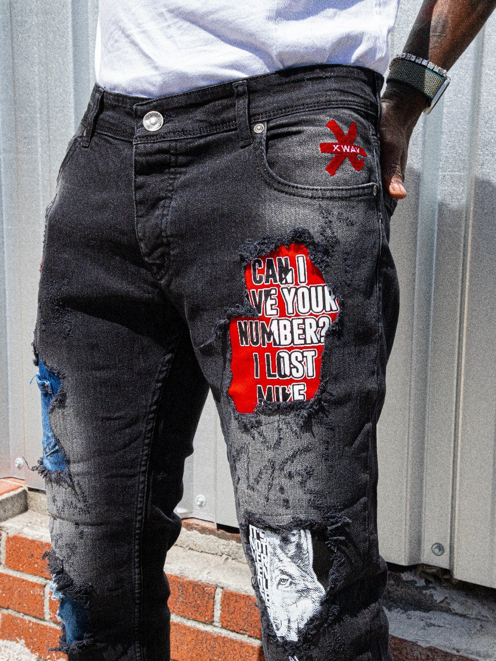A man wearing a pair of INSIDER ripped skinny fit jeans.