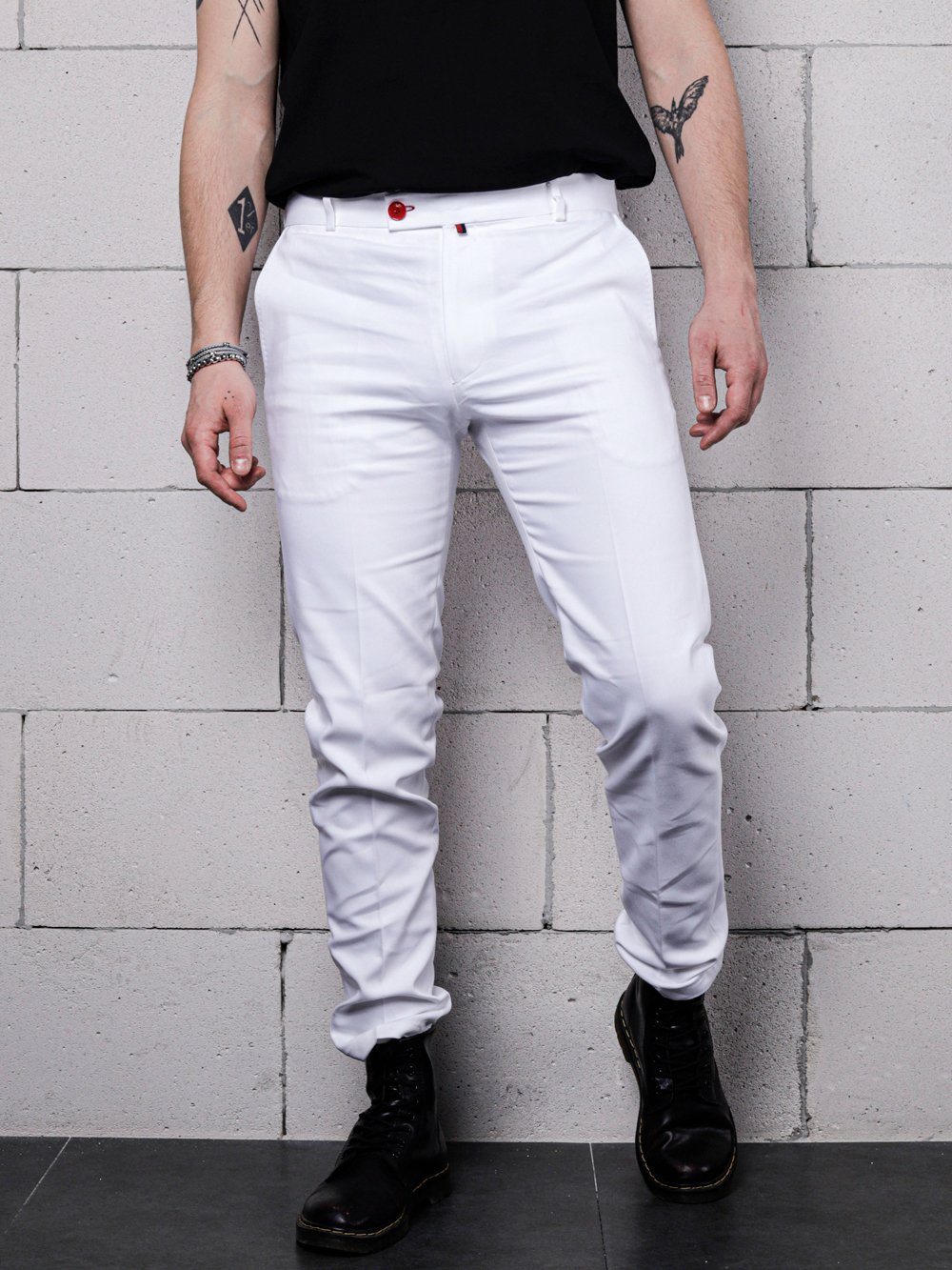 A man wearing cream Frappuccino pants and a black shirt.