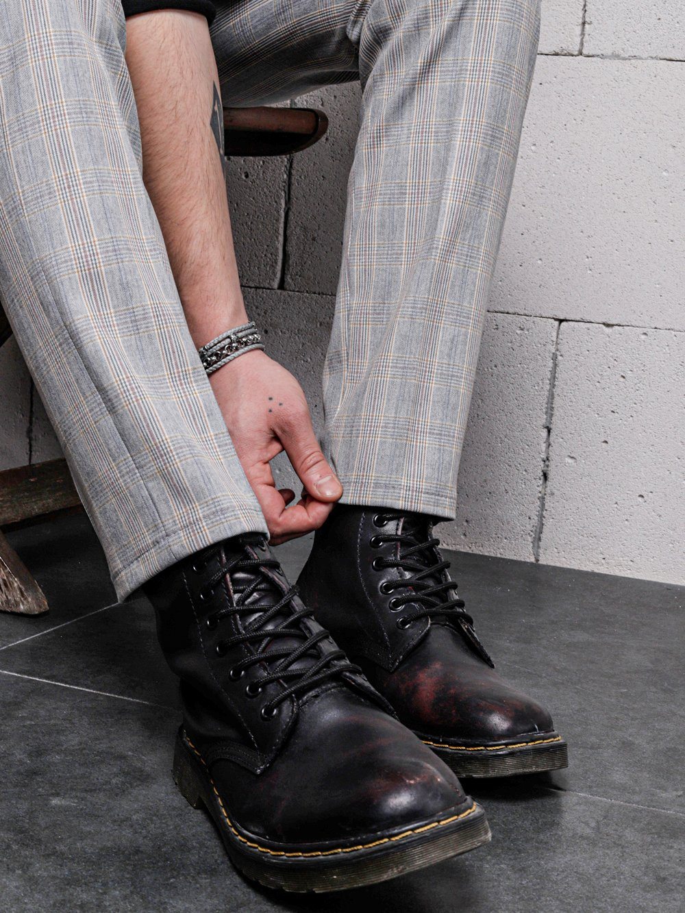 Close up shot of a man touching the hem of VANILLA LATTE Striped Pants for men by SERNES STREETWEAR