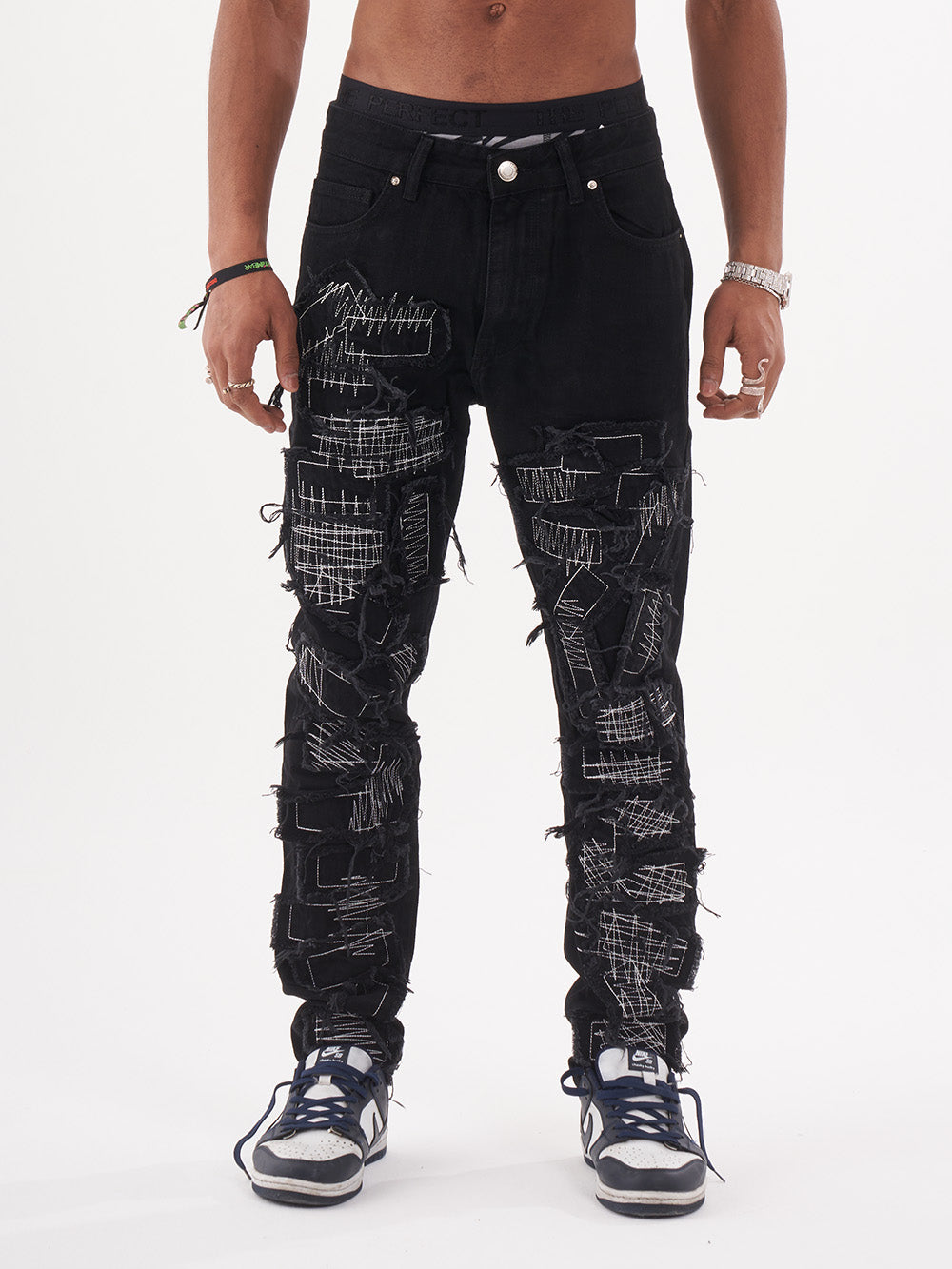 Lower body shot of a man in a black color BLUEPRINT streetwear jeans by SERNES