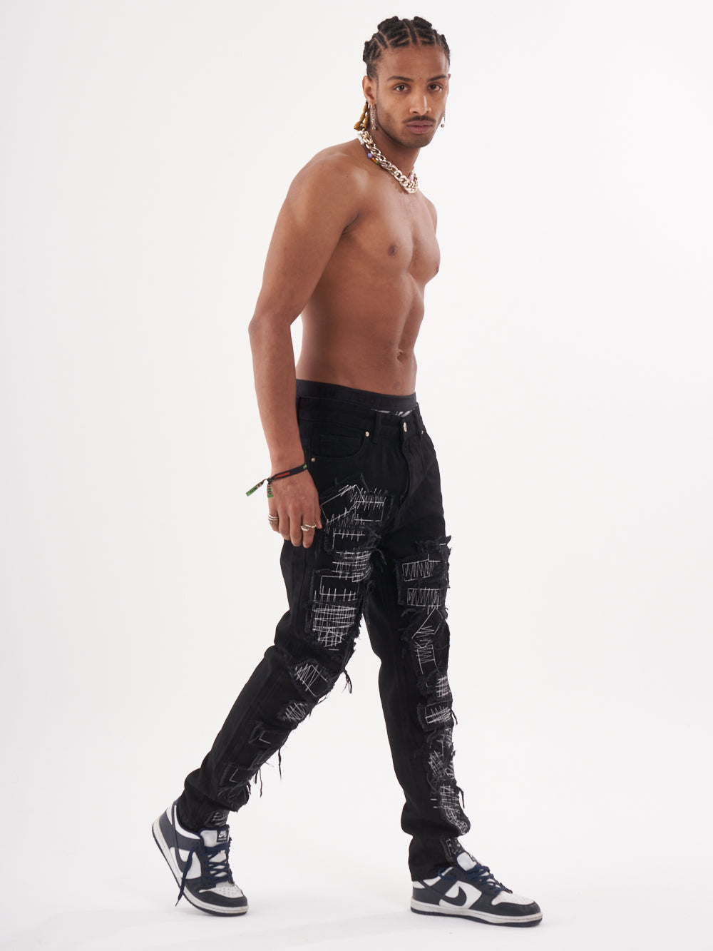 Full body shot of a man in a black color BLUEPRINT streetwear jeans by SERNES